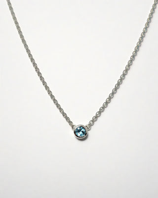 A blue topaz solitaire necklace in silver