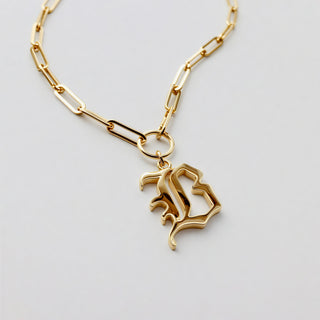 A gold initial necklace with letter B