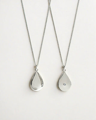A silver raindrop pendant necklace with a hidden diamond.