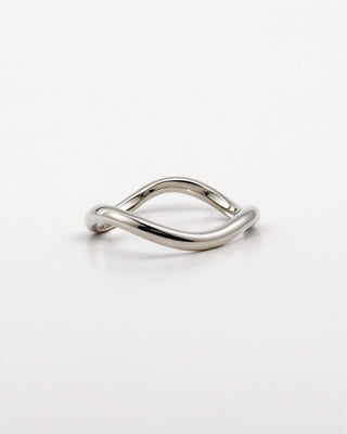 Silver ring with a wave design on a white background